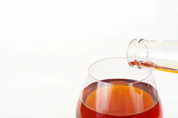 Closeup pouring elite brands from bottle into the glass — Stock Photo, Image