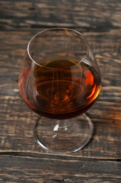 Vintage cognac in large round glass — Stock Photo, Image