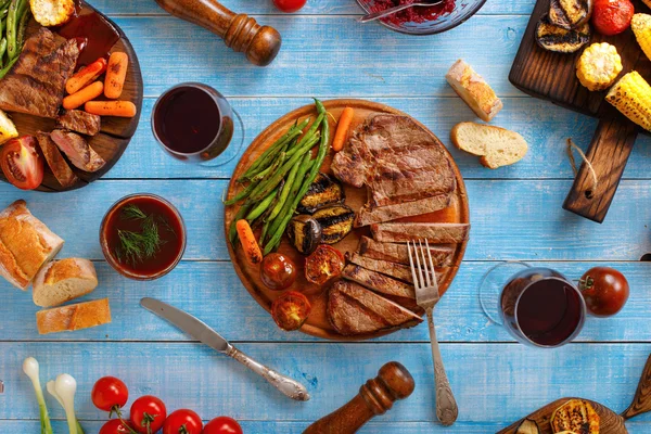 Šťavnatý steak na grilu s grilovanou zeleninou a červeným vínem — Stock fotografie