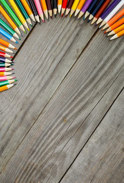 Colored pencils on wooden background with copy space — Stock Photo, Image