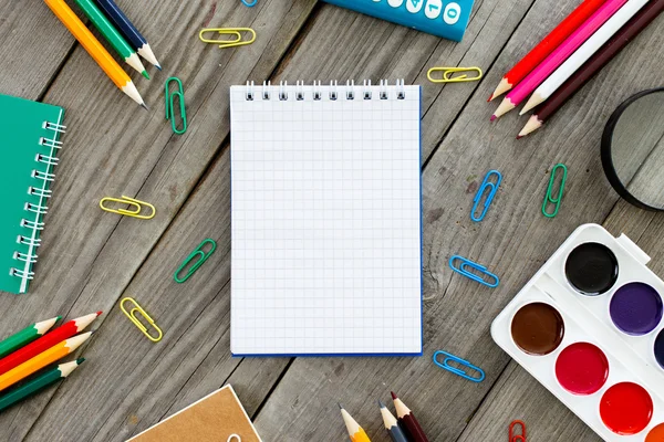 Open notebook with school different supplies — Stock Photo, Image