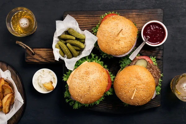 Different burger with pickles, ketchup, mayonnaise, fries and li — Stock Photo, Image