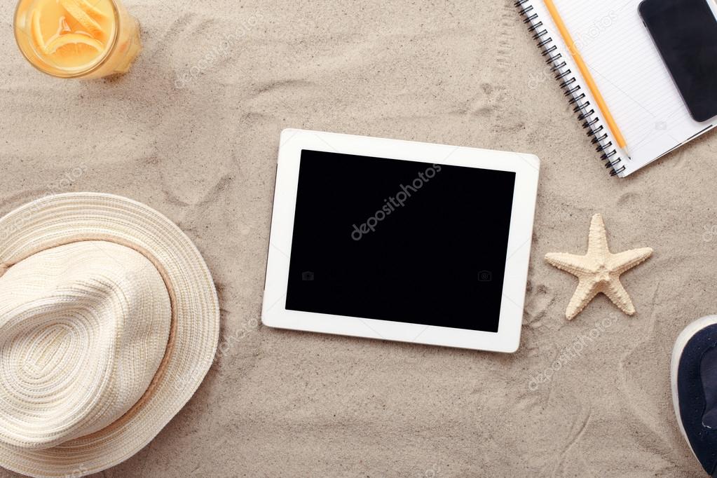 Digital tablet computer with blank screen and beach items