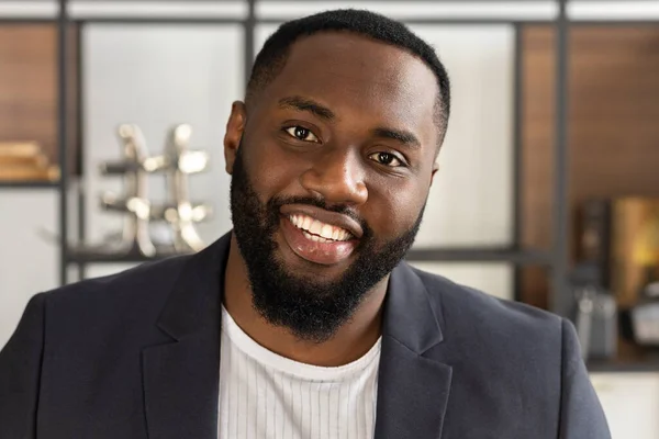 Smiling successful african american black businessman or student looking directly at the camera