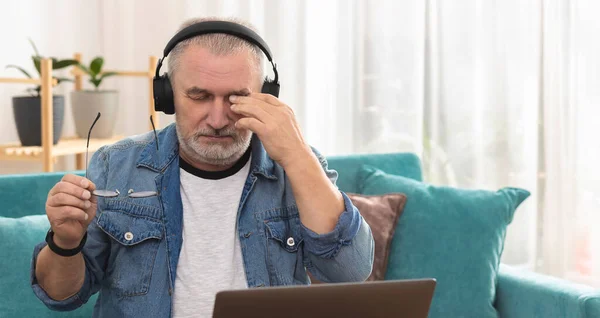 Kablosuz Kulaklıklı Yetişkin Bir Adam Laptopun Başına Oturur Yoğun Bir — Stok fotoğraf