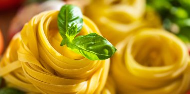 Tagliatelle with basil close up with copy space