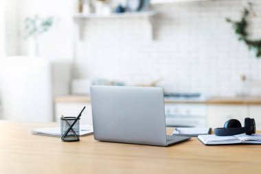 Home workplace with laptop, notebook and headphones remote work or online education concept