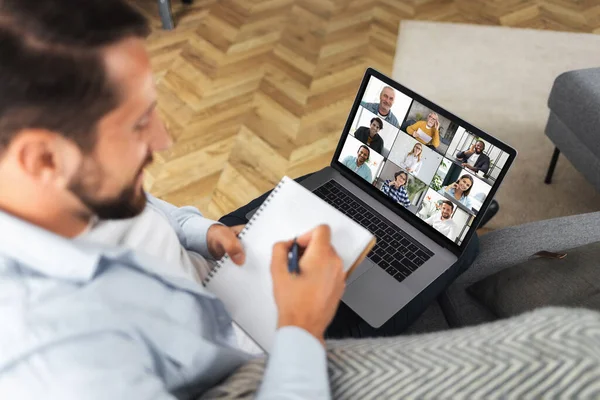 Video call, online business meeting, group brainstorm concept. Caucasian freelancer uses laptop computer for online meeting with diverse multiracial colleagues. Distance education, online learning