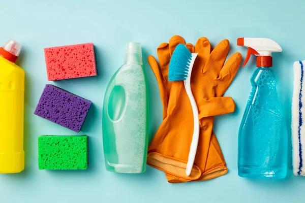 Cleaning concept. Set of cleaning supplies on blue background, top view