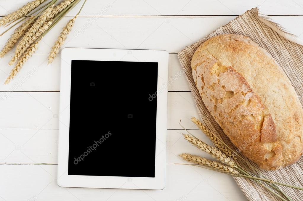 fresh bread with tablet computer
