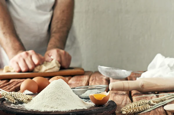 A handful of flour with egg on a rustic kitchen — Stock Photo, Image