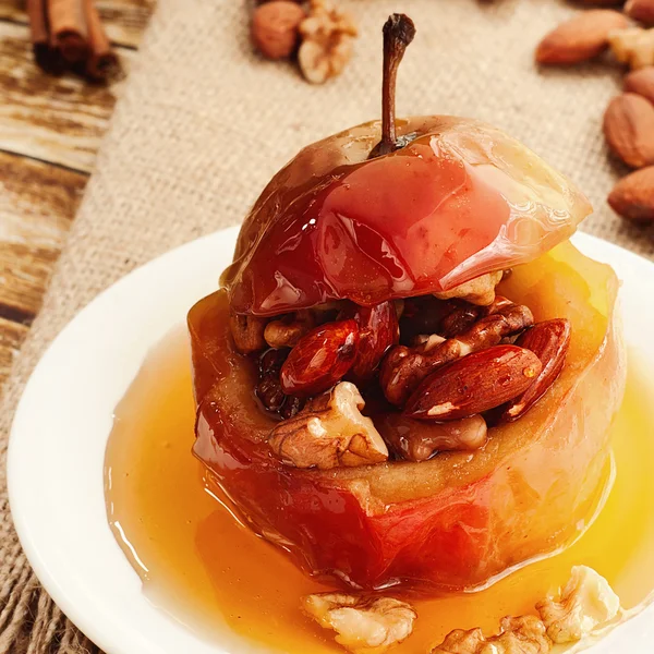 Dessert of baked apples stuffed with nuts and drizzled with hone
