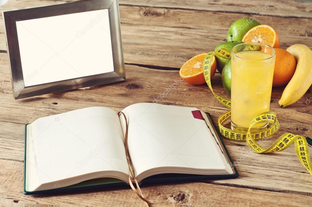 open notebook, fruit, juice on the table