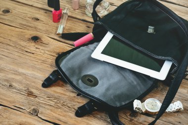 Open leather bag with womens cosmetics