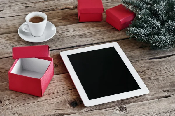 White tablet computer with open Christmas gifts