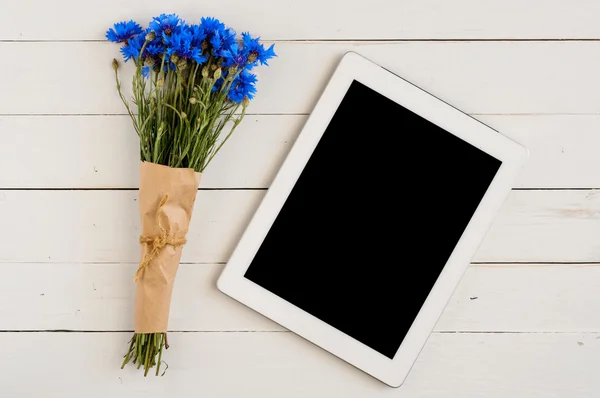 Buquê de flores silvestres com computador tablet — Fotografia de Stock