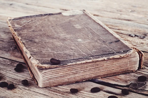 Old book in coffee beans closeup — ストック写真