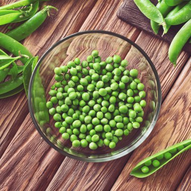 green peas peeled in a glass bowl closeup