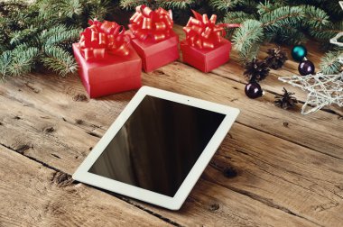 white tablet with Christmas presents close up