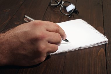man writes in a notebook clipart