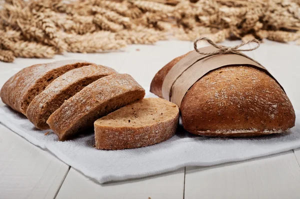 Ciabatta with ears of wheat — Stock Photo, Image