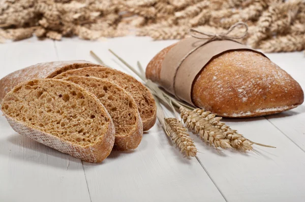Ciabatta with ears of wheat — Stock Photo, Image