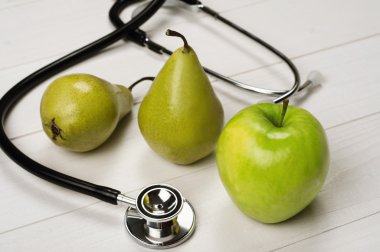 Fruits (apples and pears) with stethoscope clipart