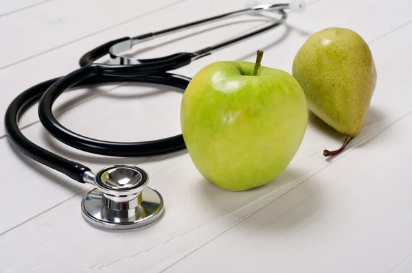 Apple and pear with stethoscope — Stock Photo, Image