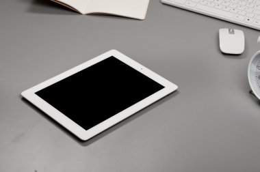 White tablet computer on a grey table