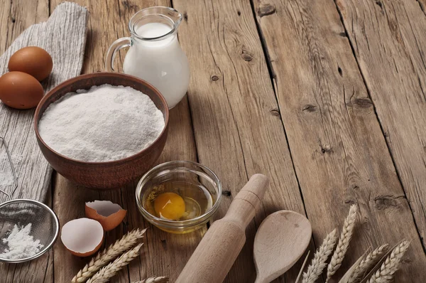 Flour, egg, milk on wooden table rustic kitchen — Stock Photo, Image