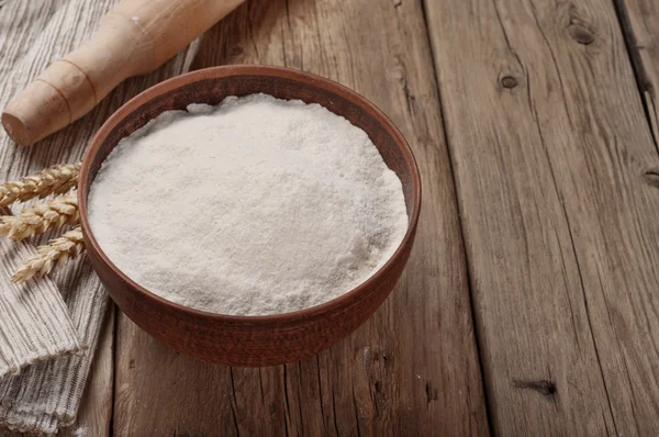 Flour in a clay bowl — Stok fotoğraf