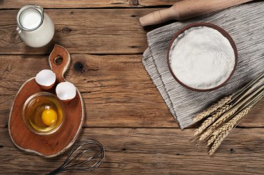 Flour, milk, eggs, in the bakery on a rustic table