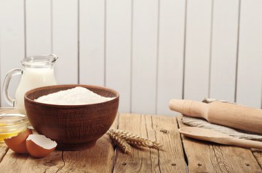 Flour in a bowl on a rustic wooden kitchen table