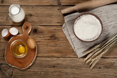 Flour in a bowl with ingredients for preparing baked products