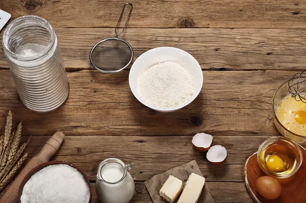 Bowl of flour with ingredients for baking — Stock Photo, Image