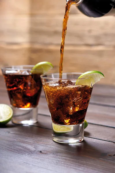 Verser le rhum et le cola cuba libre à la lime, glace — Photo