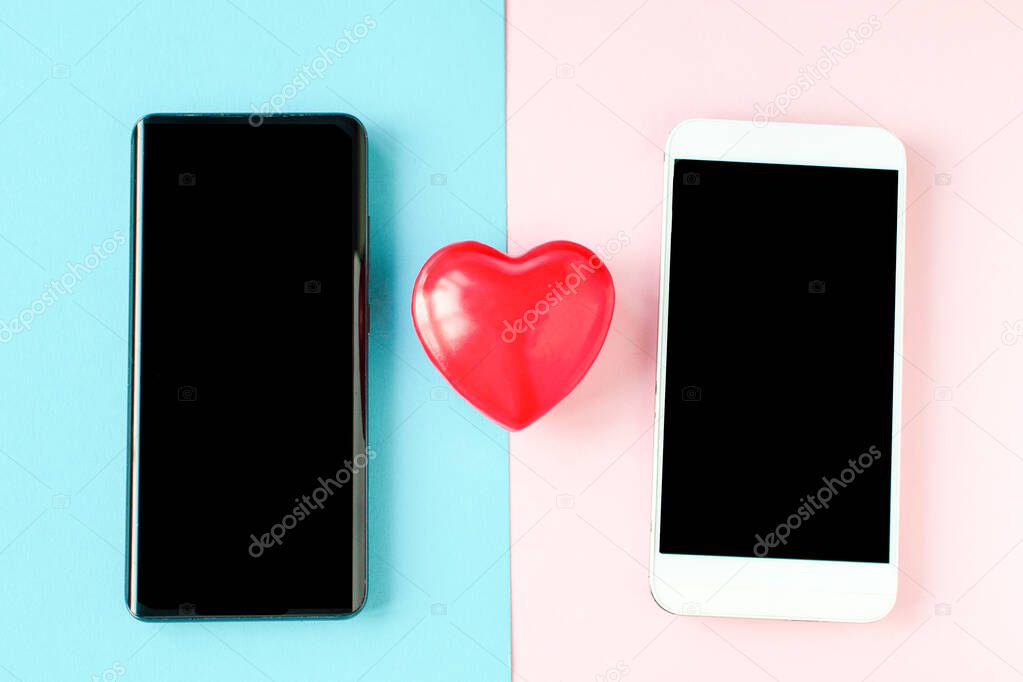 Valentines Day Coronavirus two phones and a heart. Covid-19 Valentine. Online communication, virtual love, loneliness web Internet, love texting, messaging, online dating. St. Valentine's day concept