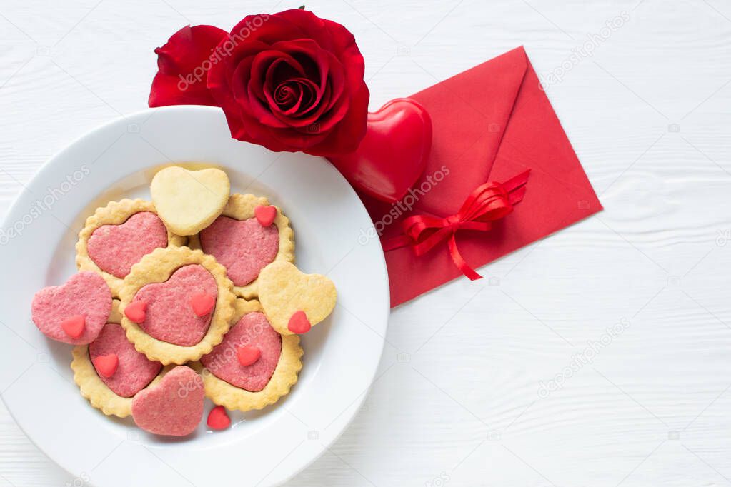 Valentine day cookies on a plate Step by step 5. Red rose, letter valentine and heart. Love concept. Delicious homemade natural organic heart shaped cookies, baked goods with love for valentines day.