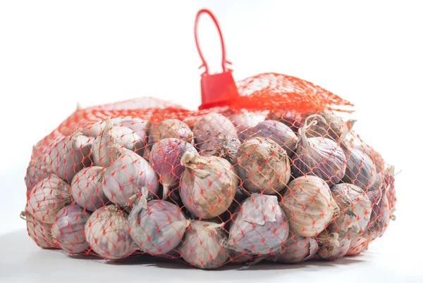 Garlic in bag — Stock Photo, Image