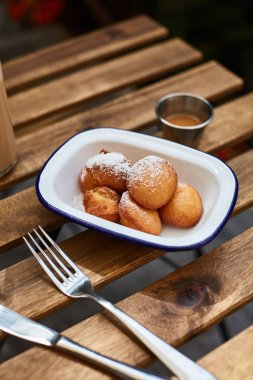 Tahta bir masada pudra şekerli çörekler.