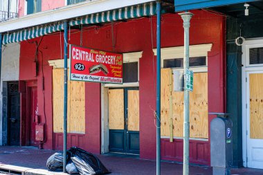 NEW ORLEANS, LA, USA - APRIL 24, 2020: Central Grocery in the French Quarter boarded up during Corona Virus shutdown clipart