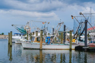 METAIRIE, LA, USA - MAY 28, 2020: Fishing boats and trawlers in Bucktown harbor on Lake Pontchartrain clipart