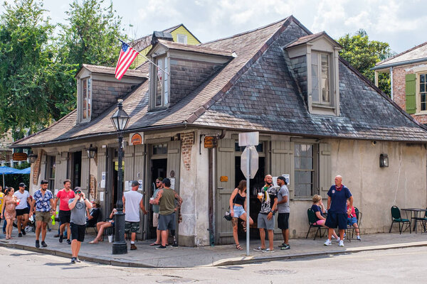 NEW ORLEANS, LA, USA - JULY 12, 2020: People gathered at Jean Lafitte's Blacksmith Shop in the French Quarter