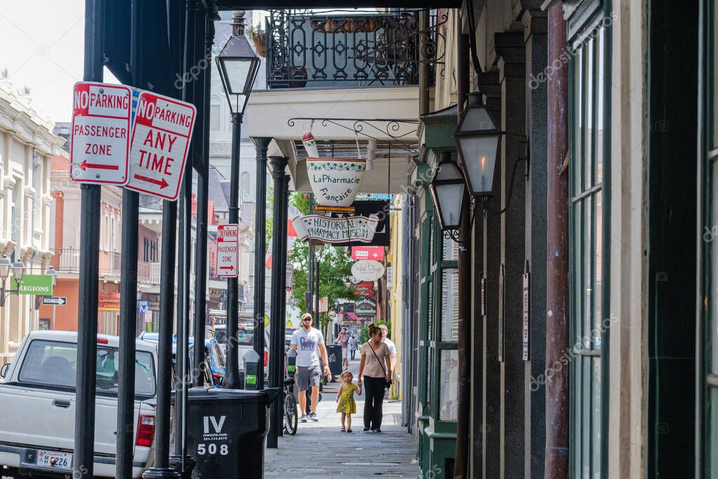 NEW ORLEANS, LA, USA - JULY 8, 2020: Tourists walking near the Pharmacy Museum on Chartres Street in French Quarter