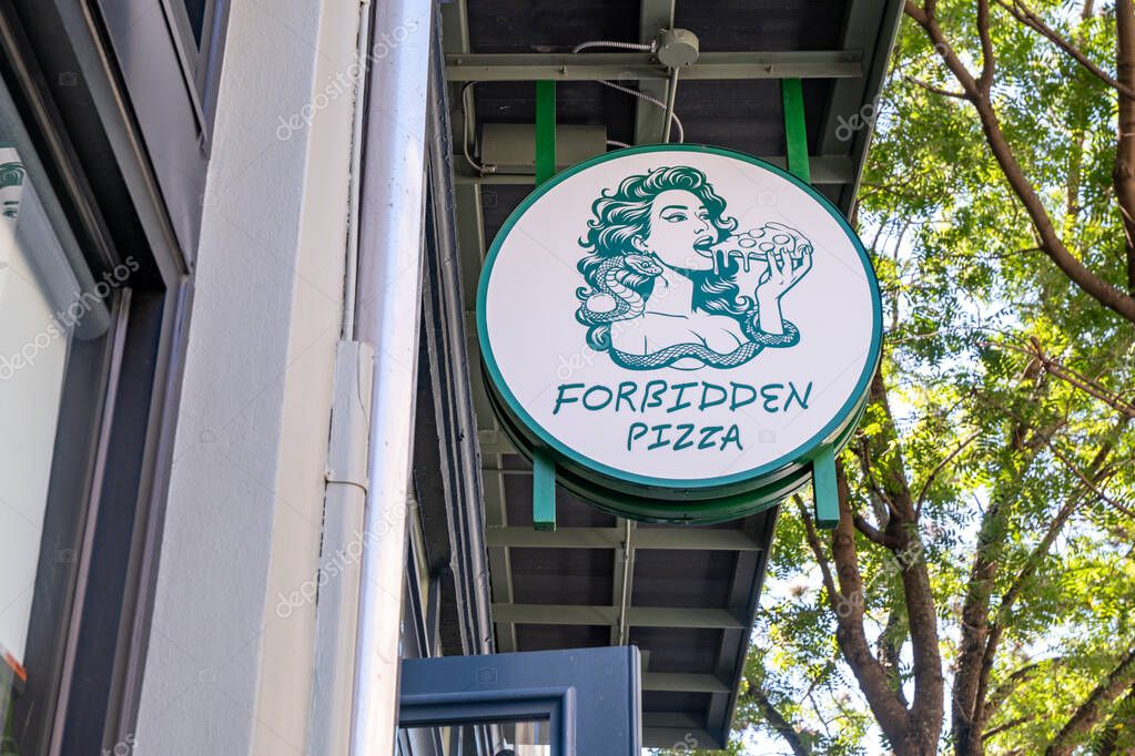 New Orleans, LA, USA - October 12, 2025: Forbidden Pizza sign at the entrance to the pizzeria in Downtown New Orleans