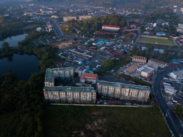 aerial view apartment buildings near lake and around scenic mountains at sunrise, Phuket Thailand
