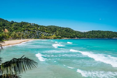 View on long large waves in the turquoise lagoon surrounded green hills. Summer vacation and nature travel adventure concept.. Summer composition. High quality photo