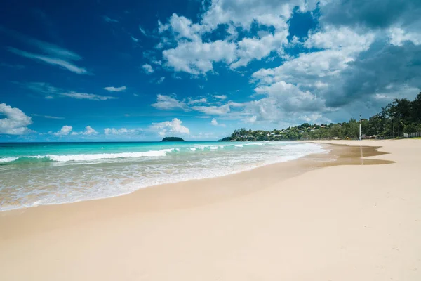 Beautiful tropical beach with white sand, palm trees, turquoise ocean against cloudy sky on summer day. Perfect landscape background for relaxing vacation. Summer vacation and nature travel adventure concept.. Summer composition. High quality photo