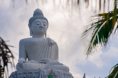 29.05.2021 - Phuket, Thailand. big white marble buddha isolated on cloudy background, copy space. High quality photo