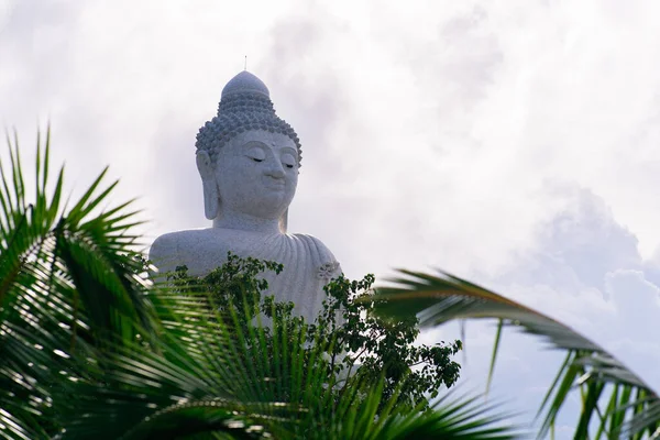 29.05.2021 - Phuket, Thailand. big white marble buddha isolated on cloudy background, copy space. High quality photo